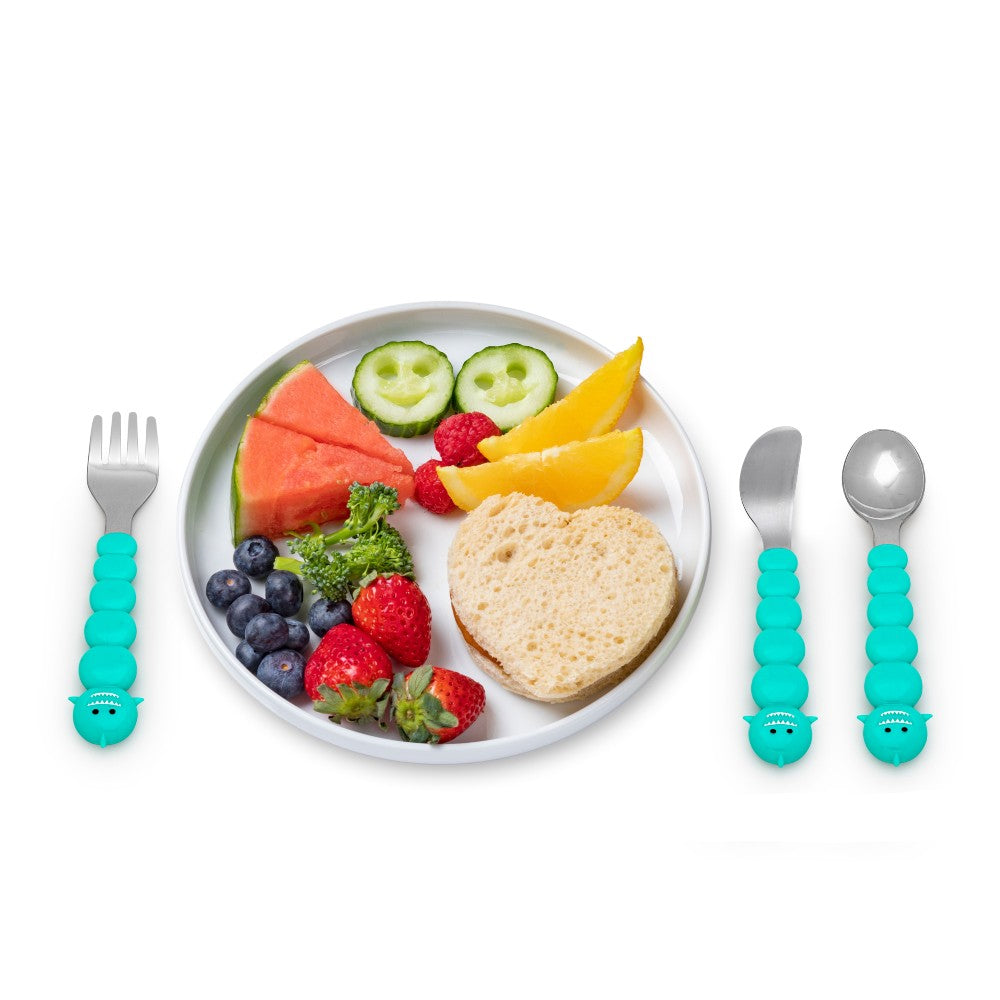 Toddler cutlery set shark shape handles  and white plate with children's food on white background