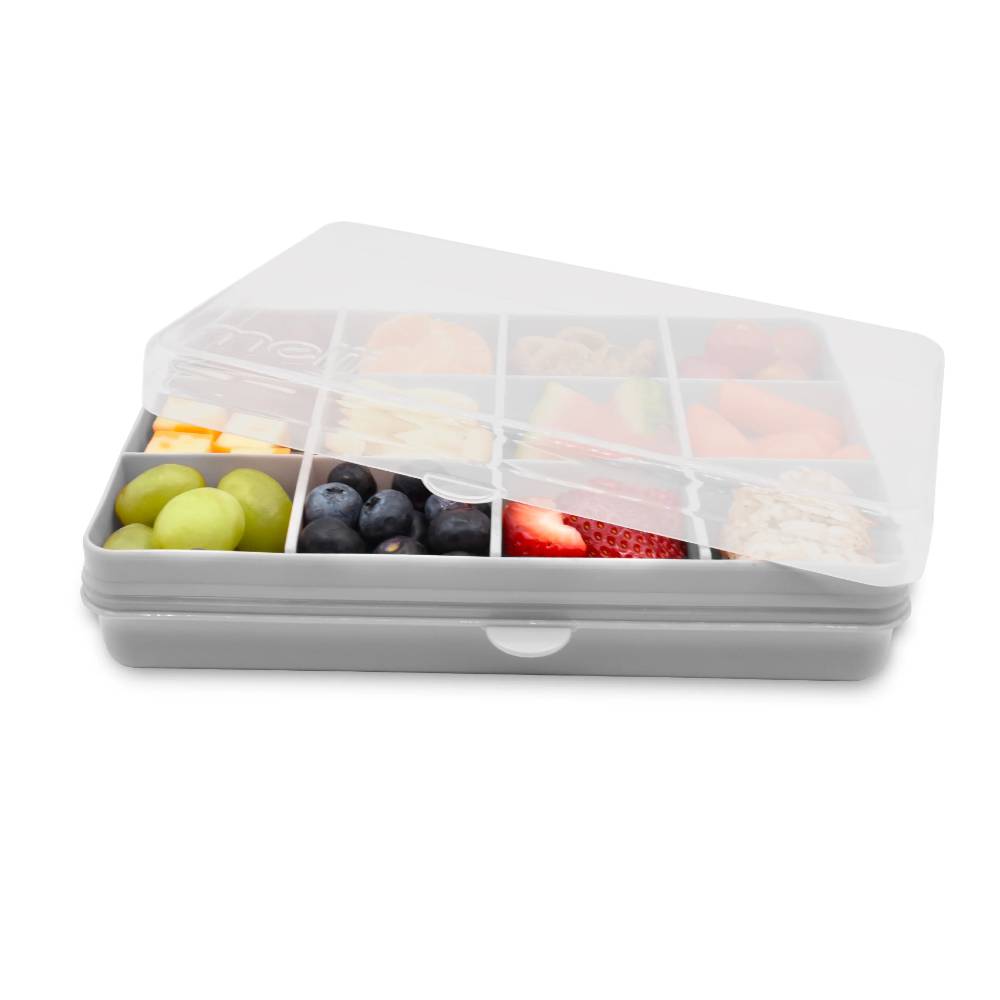Gray compartmentalized food container with fruits and vegetables on a white background