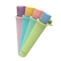 Set of four colorful silicone ice cream molds on a white background