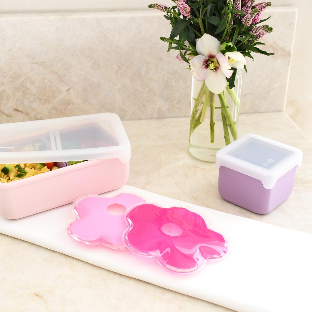 Pink floral silicone mat with a pink container and a white container on a marble surface.