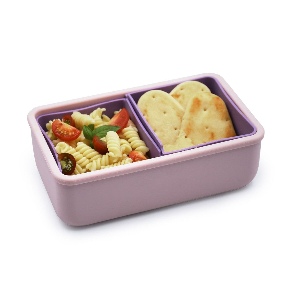 Purple bento box with pasta salad and crackers on a white background