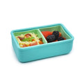 Turquoise bento box with compartments filled with pasta salad and berries on a white background