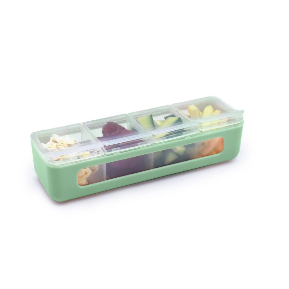 Green plastic container with compartments filled with various food items on a white background