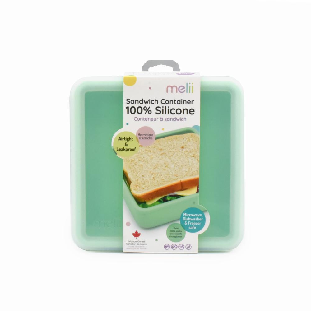 Green silicone sandwich container with packaging on a white background
