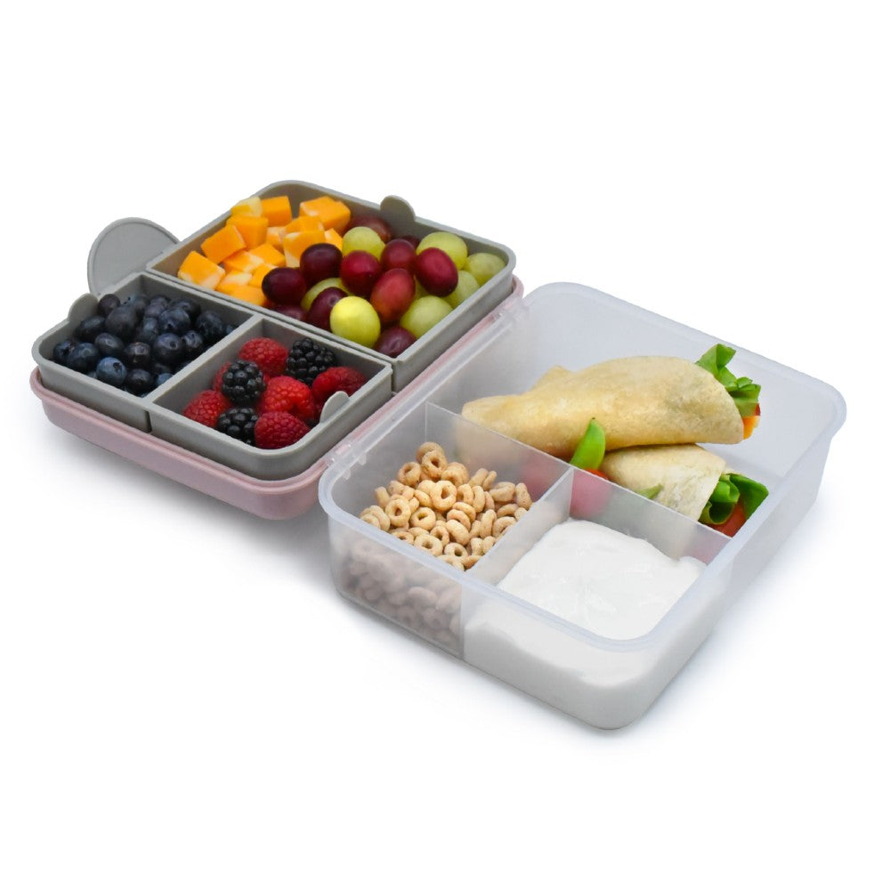 Multicolored bento box with compartments of fruits, vegetables, and other snacks on a white background