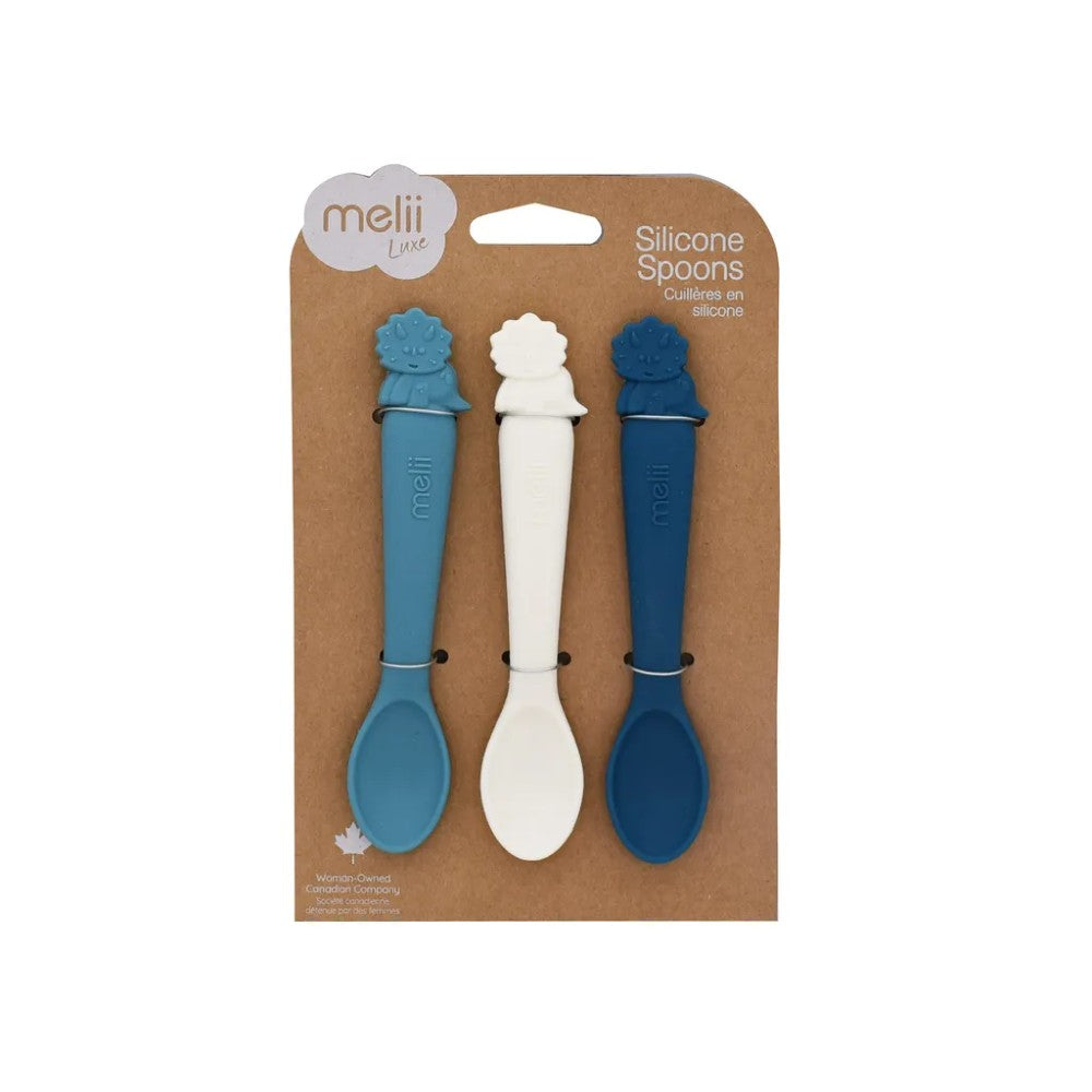 Packaging of three silicone spoons with blue and white handles on a brown background