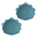 Two blue dinosaur suction silicone bowls with textured surface on a white background