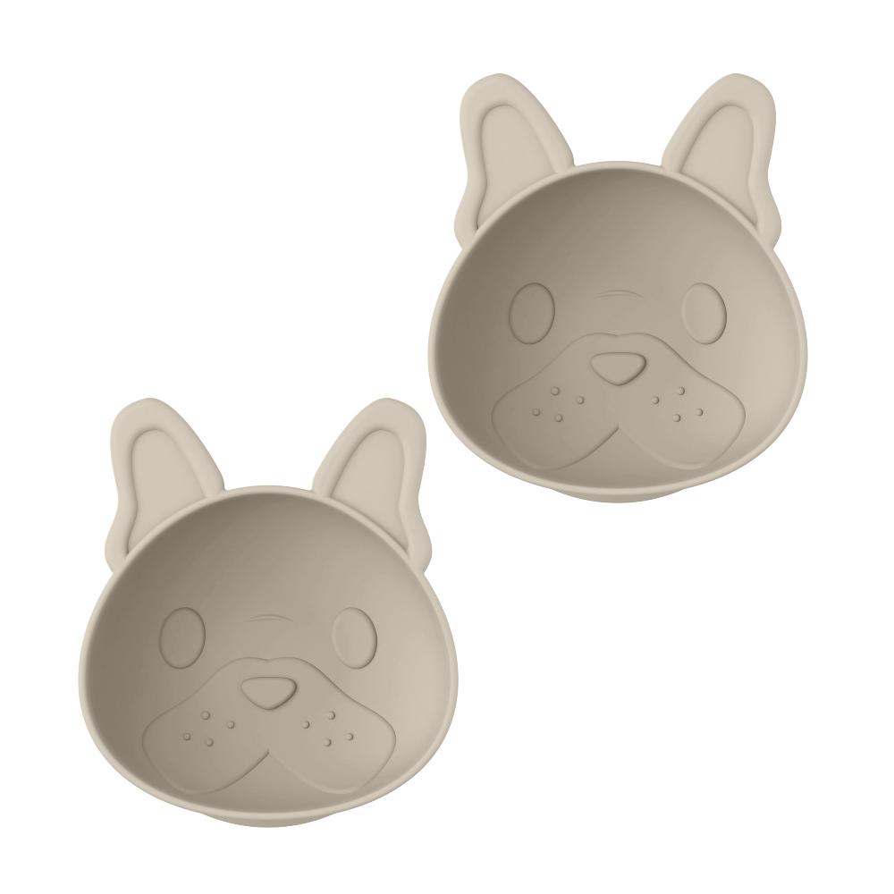 Two beige bulldog shaped like dog faces baby suction bowls on a white background