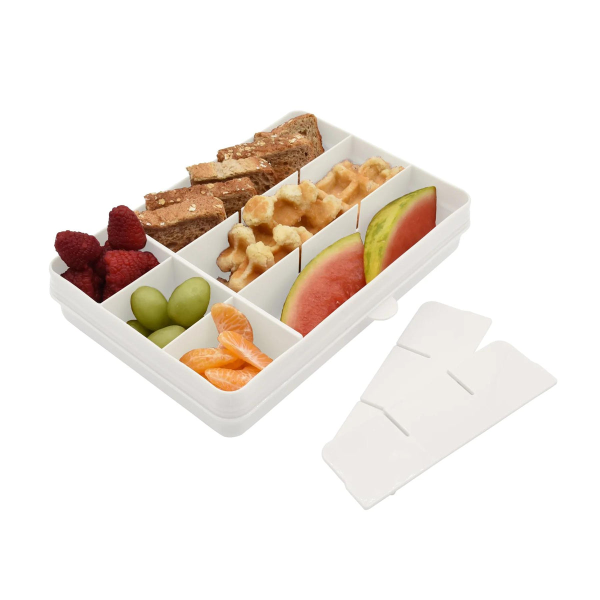 Cream colour compartmentalized snack box with assorted snacks including fruits and cookies on a white background