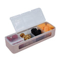 Rectangular snack container with compartments filled with various snacks on a white background