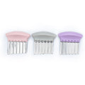 Three tools for cutting children's food in patterms with pink, gray, and purple handles on a white background