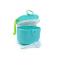 Turquoise baby formula powder container with a white spoon on a white background