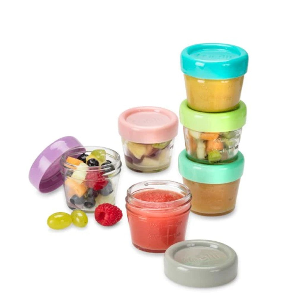 Set of colorful glass baby food storage containers with lids on a white background