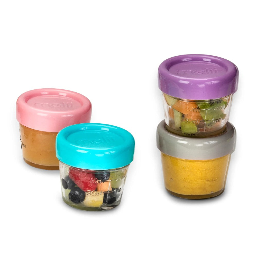 Set of four Melii glass colorful food storage containers with lids on a white background