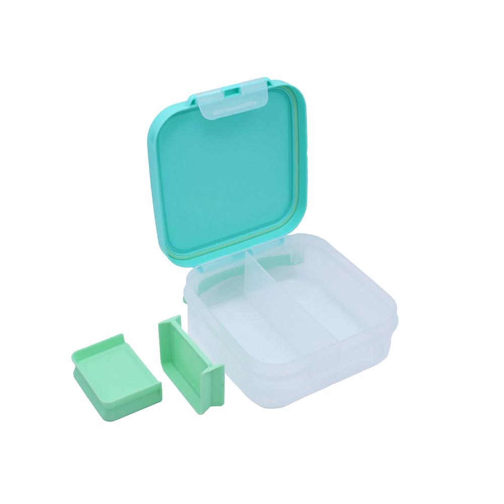 Green and clear plastic  BPA free bento with a lid on a white background