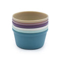 Stack of colorful silicone baking cups on a white background