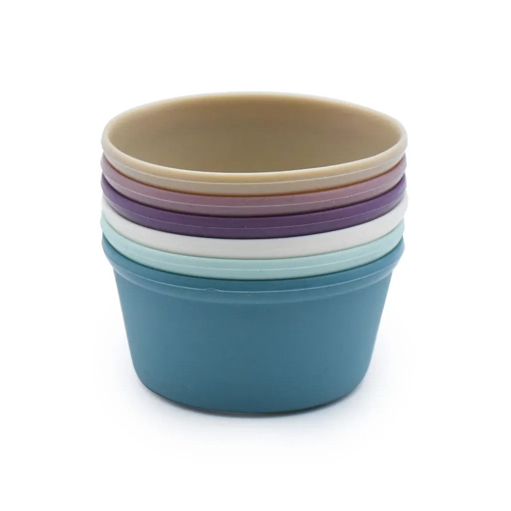 Stack of colorful silicone baking cups on a white background