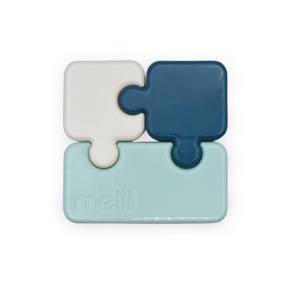 bento Box in puzzle piece design in blue, white, and light blue on a white background