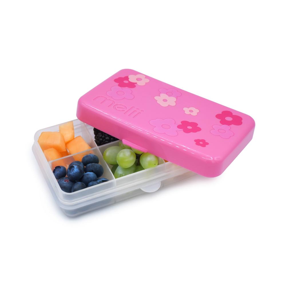 Pink snack container with floral designs filled with fruits on a white background