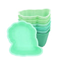 Set of green silicone food cups on a white background
