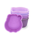 Set of purple silicone containers with animal shapes on a white background