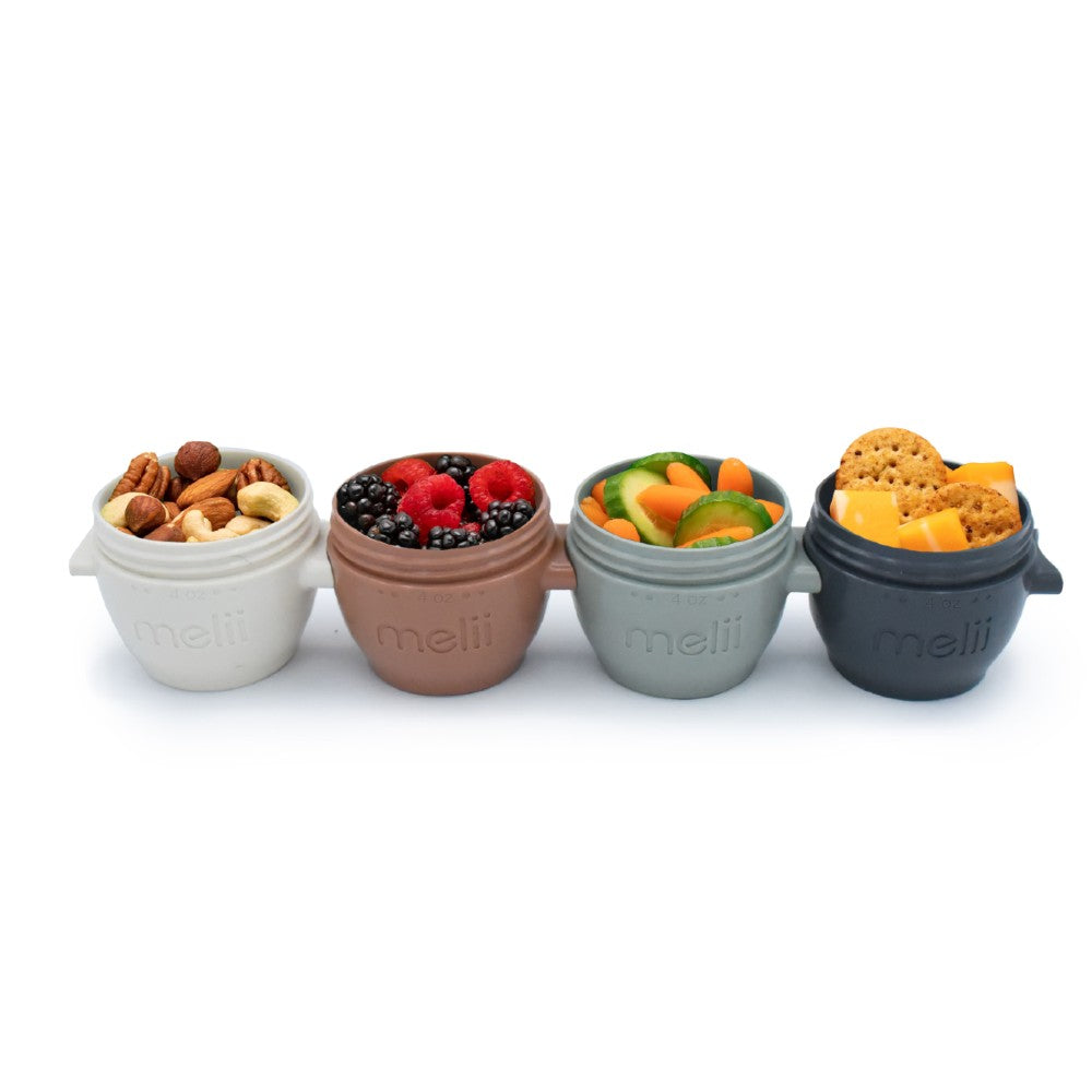 Four small containers with snacks labeled 'meli' on a white background
