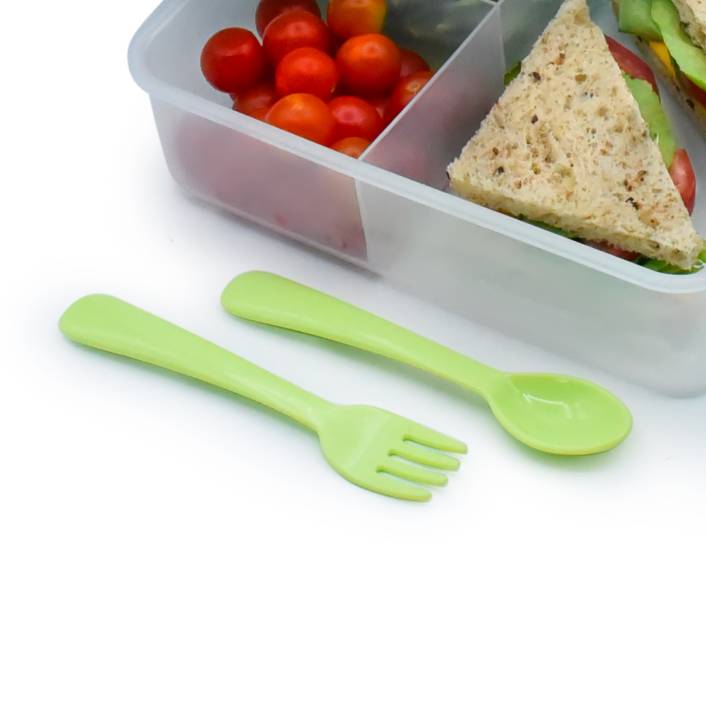 Bento box with cherry tomatoes and a sandwich, accompanied by green plastic fork and spoon on a white background.