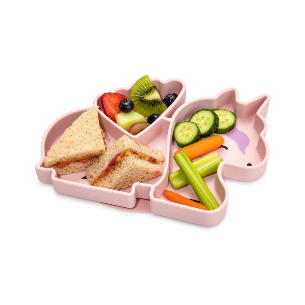 Pink unicorn-shaped divided plate box with snacks on a white background