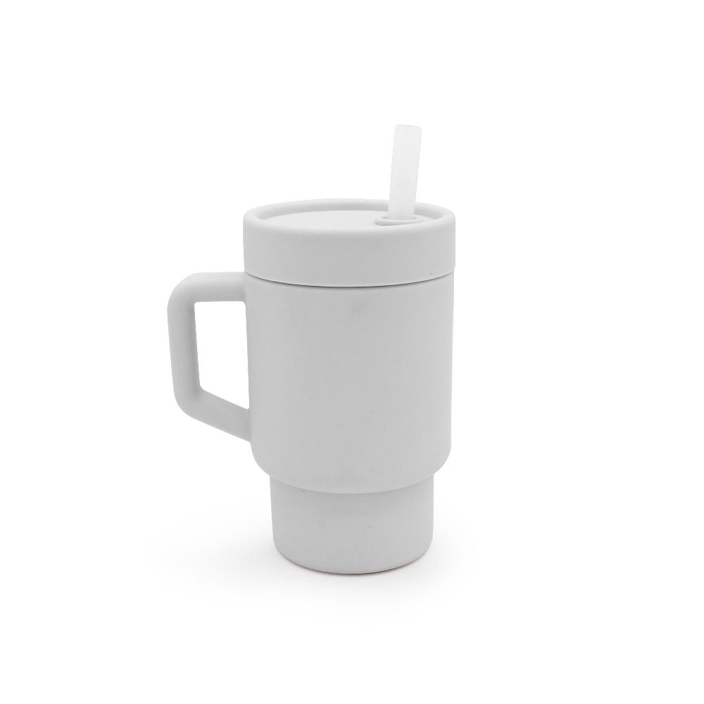 Silicone trainer sippy cup in BPA free silicone with handle and straw on a white background