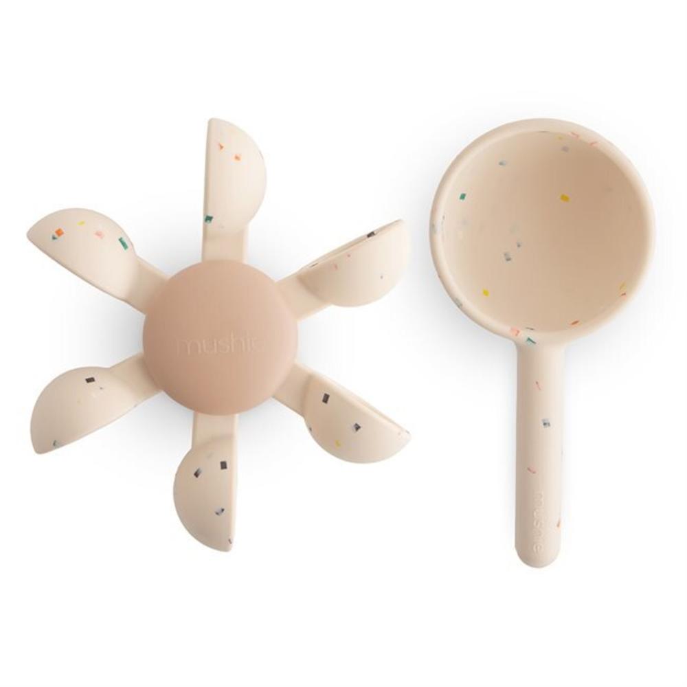 Two beige baby toys with colorful speckles on a white background