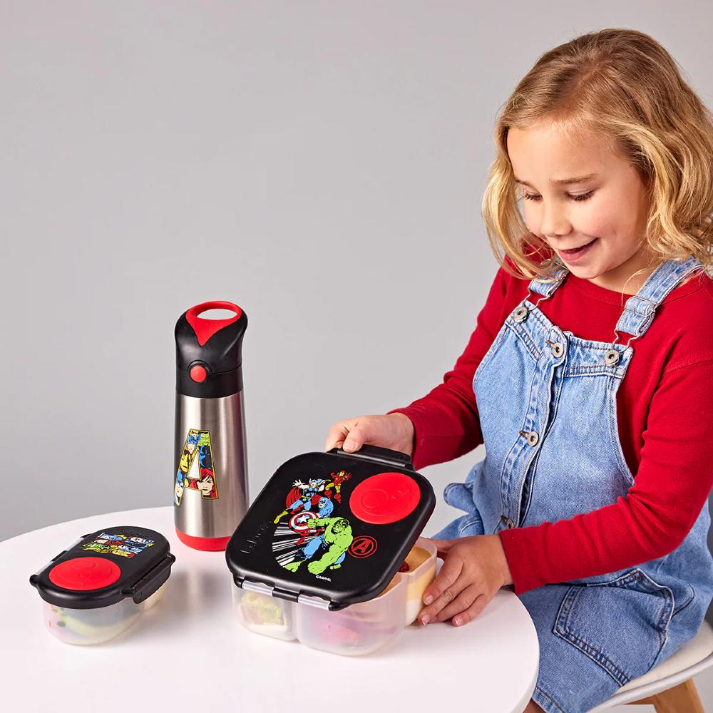 Child interacting with a marvels mini lunch box set including a lunchbox, snack box, and bottle on a gray background