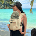 A woman holding her baby in a Mini Monkey Toddler carrier in the colour Sand 