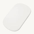 A white, oval-shaped mattress with rounded corners, shown on a solid off-white background.