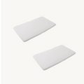 Two rectangular white mattresses with rounded corners and white sheets, shown on a plain off-white background.