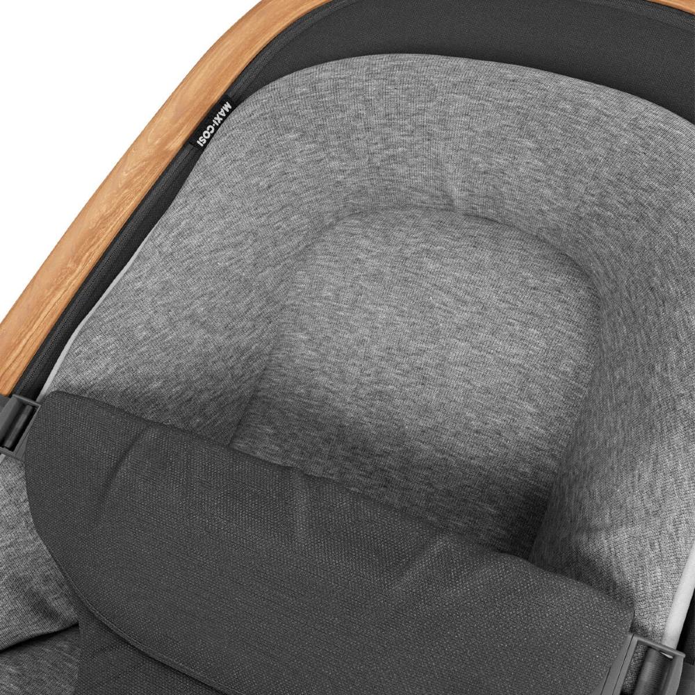 Close-up of a bouncer with a heather gray fabric insert and a dark gray padded support, shown on a stroller frame with a light wood accent.