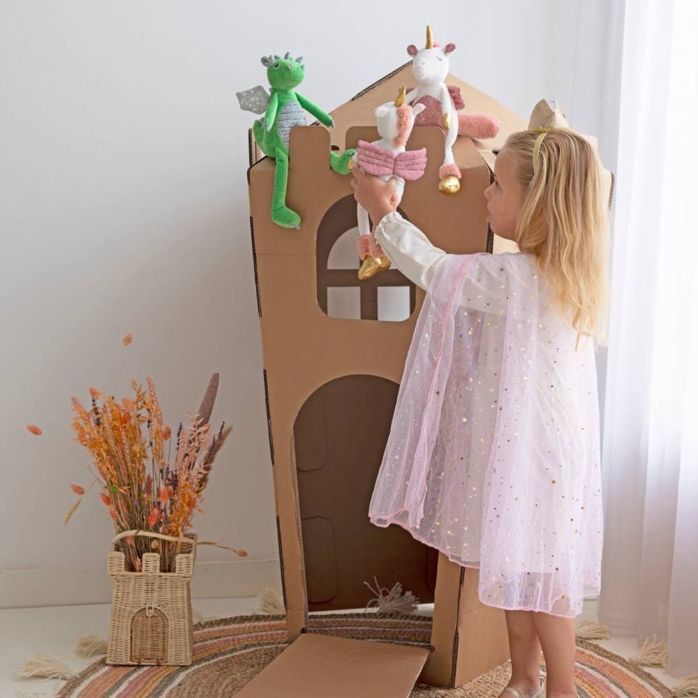 A girl playing with 2 Happy Horse Unicorns & Dragon Soft Toys. 