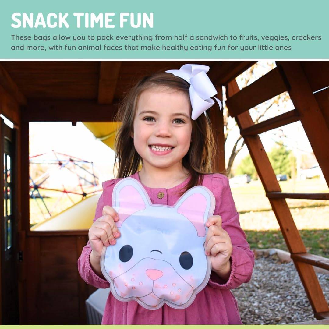 Child holding a pink and white snack bag with an animal face design outdoors.