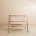 Beige Bassinet in a nursery setting