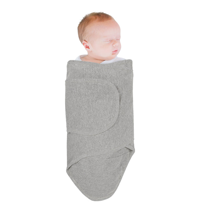 Newborn baby wrapped in a grey miracle blanket swaddle on a white background