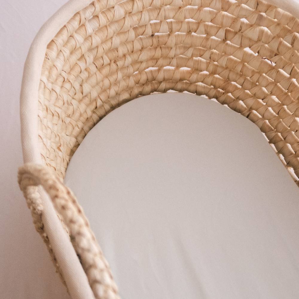 Close up of a moses basket mattress in a moses basket. 