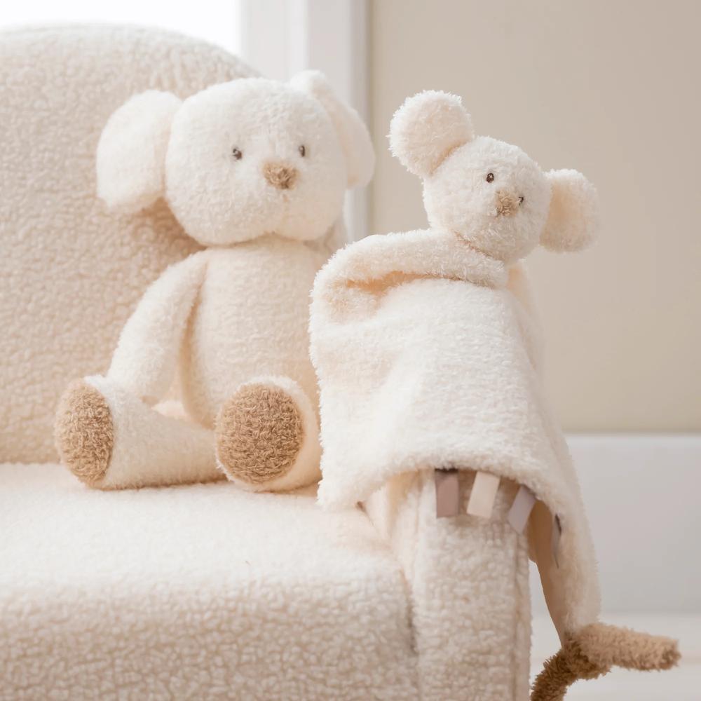 Two plush mouse toys, one with a blanket, on a soft surface.