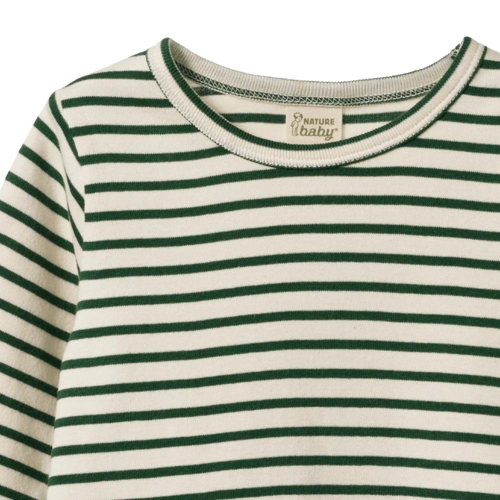 Close-up of a green and white striped organic cotton shirt with 'Nature Baby' label.