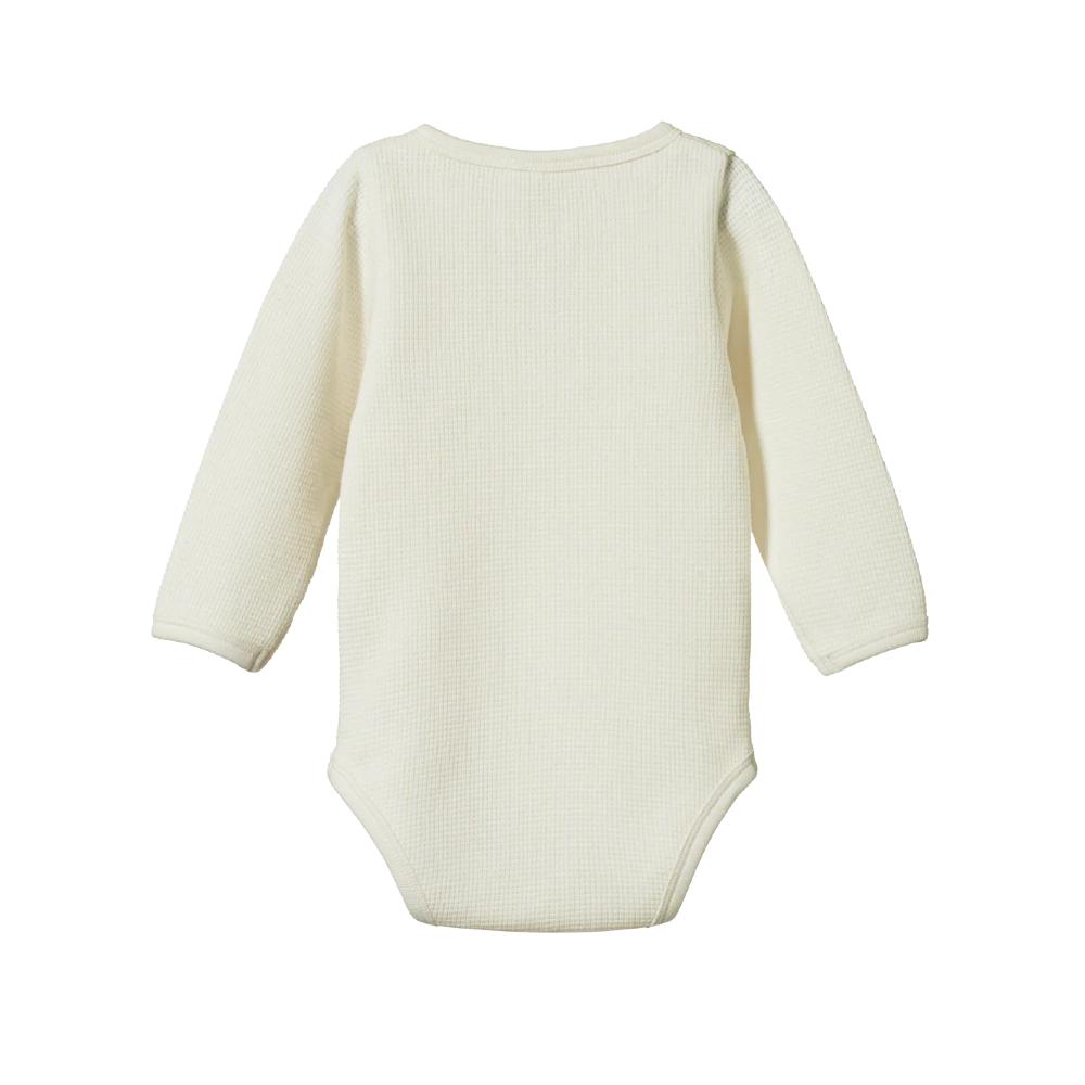 Cream baby bodysuit with long sleeves and waffle texture on a white background