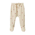 Cream footed cotton baby pants with small red radish print and cream waist tie on a white background 
