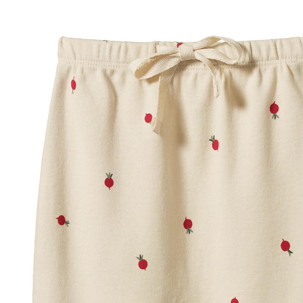 Cream pants with red radish pattern and waist tie on a white background