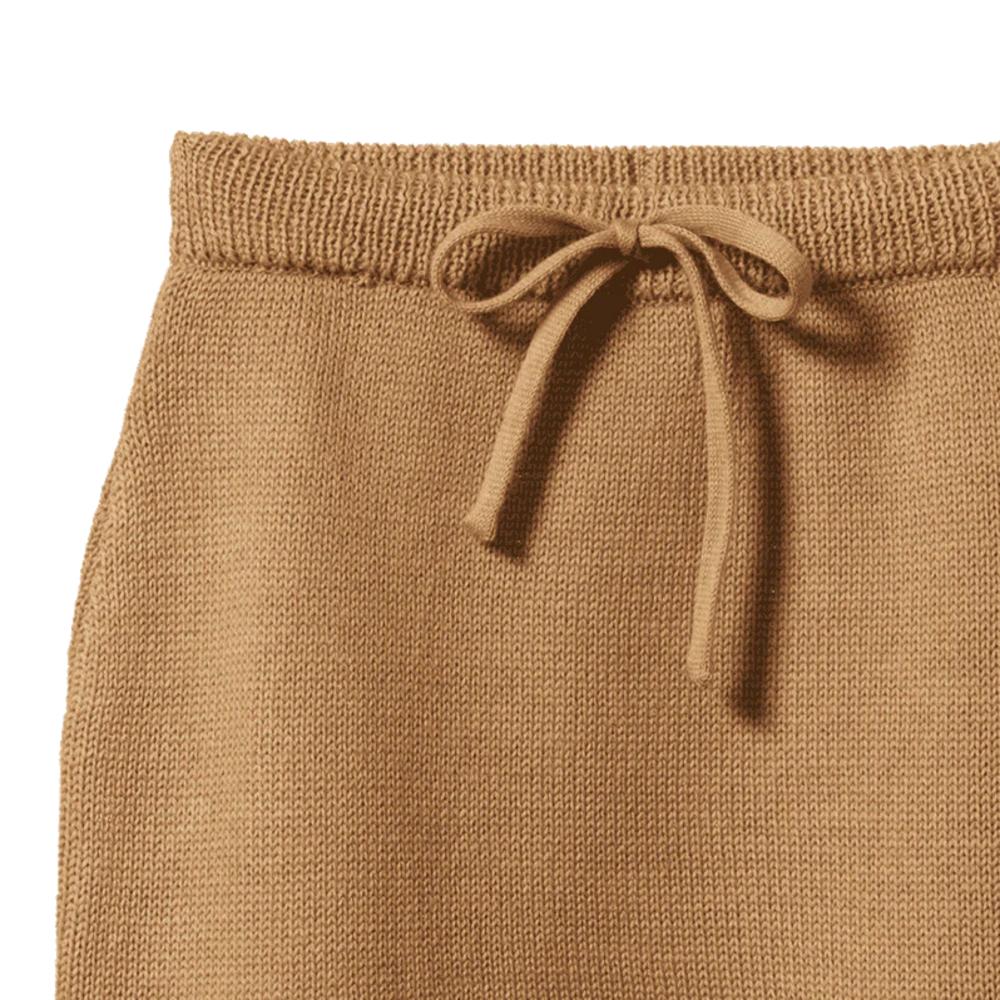 Close-up of brown knit pants with a drawstring on a white background