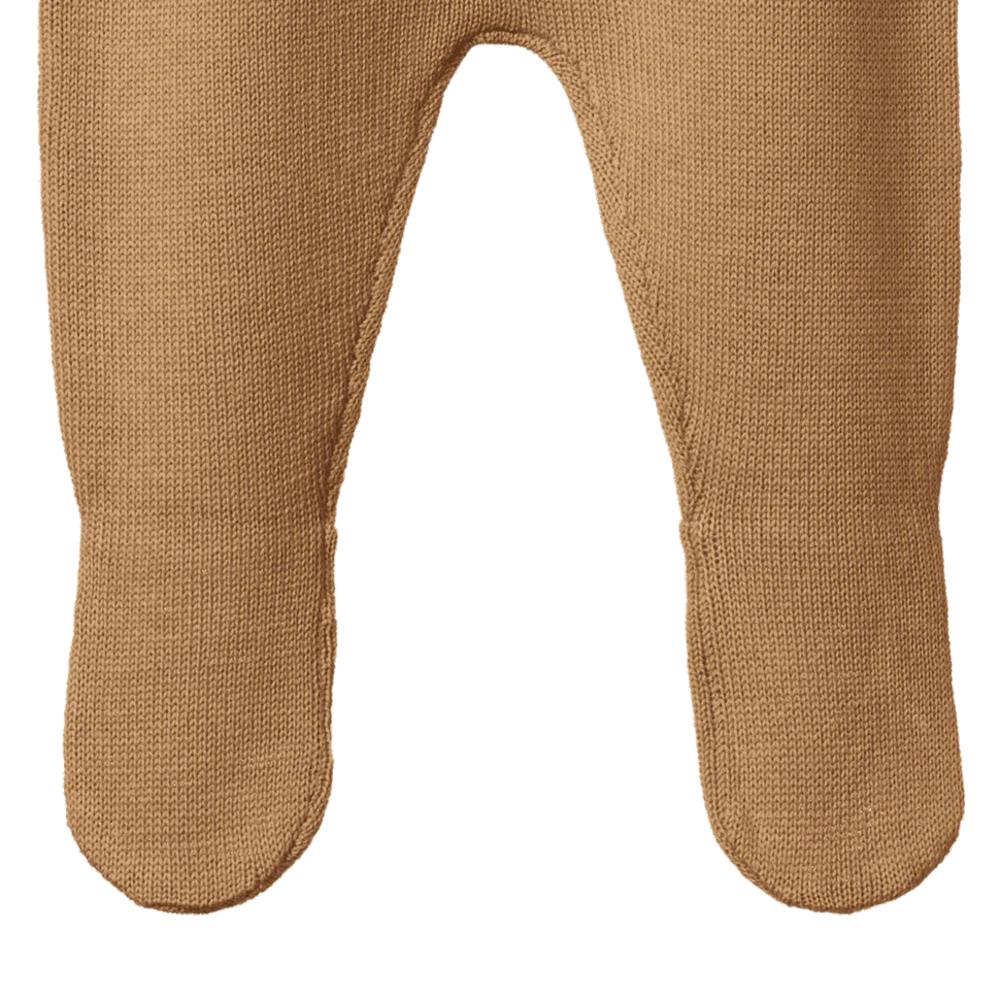 Close-up of caramel coloured baby footed pants on a white background