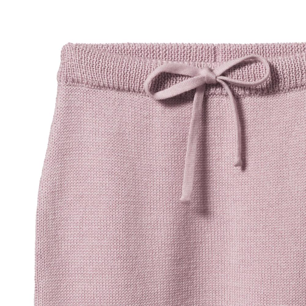 Close-up of soft pink knitted pants with a drawstring on a white background