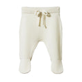 Cream knitted baby footed pants with a drawstring on a white background