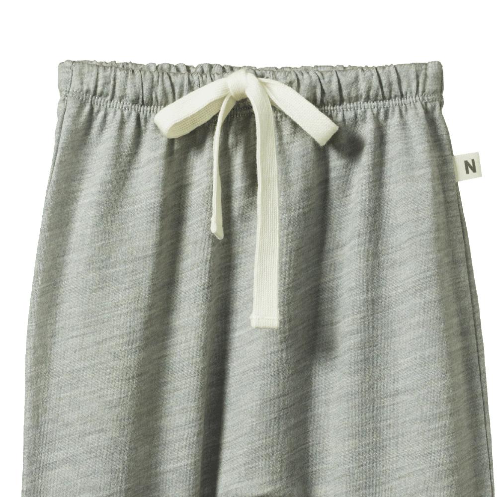 Close-up of Gray merino wool pants with a white drawstring and Nature Baby label on a white background